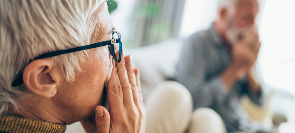 Frau putzt sich die Nase